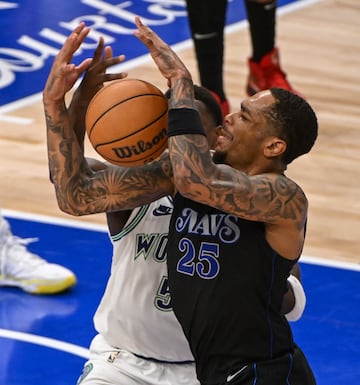 Dallas Mavericks forward PJ Washington is fouled by Minnesota Timberwolves guard Anthony Edwards.